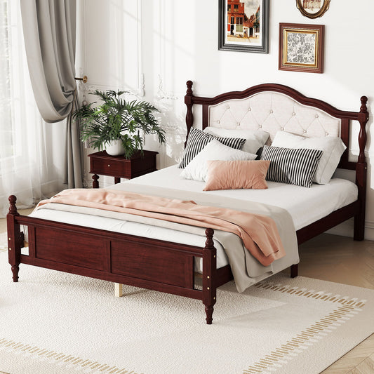 A Pine Wooden Bed with Upholstered Headboard and Panel Footboard, plus bed rail and platform support feet, stands neatly made in a bright bedroom with white walls, side table, potted plant, framed art, beige rug, pillows, and peach blanket.