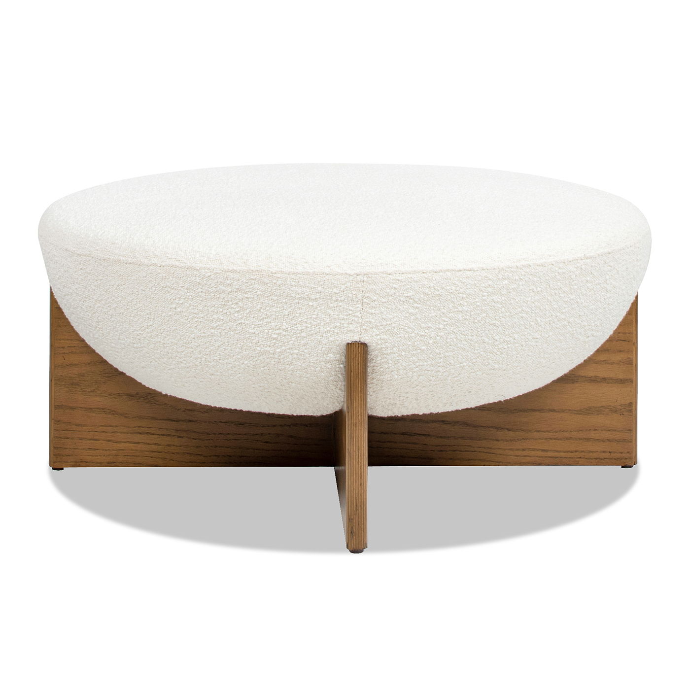 The Bali - Round Upholstered Ottoman features a modern design with a white, textured cushion and a wooden base with intersecting support panels.