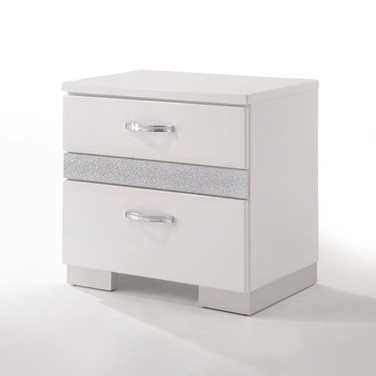 The Naima II High Gloss Nightstand in white features two drawers with silver handles, a textured silver accent strip between drawers, and stands on rectangular legs against a plain white background.