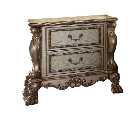 The Dresden - Vintage Nightstand features two drawers, decorative carvings, detailed handles, intricately shaped legs, and an antique finish for a classic vintage look.