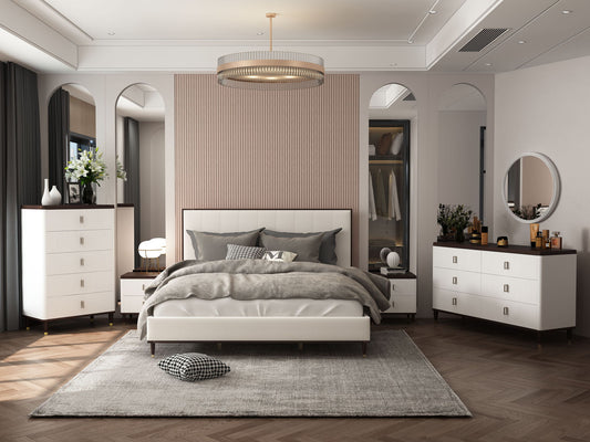 Modern bedroom featuring the Carena - Comfort Bed with neutral bedding, two nightstands, dressers, a round mirror, soft area rug, and elegant lighting. Warm tones, wood flooring, and decorative accents complete the look.