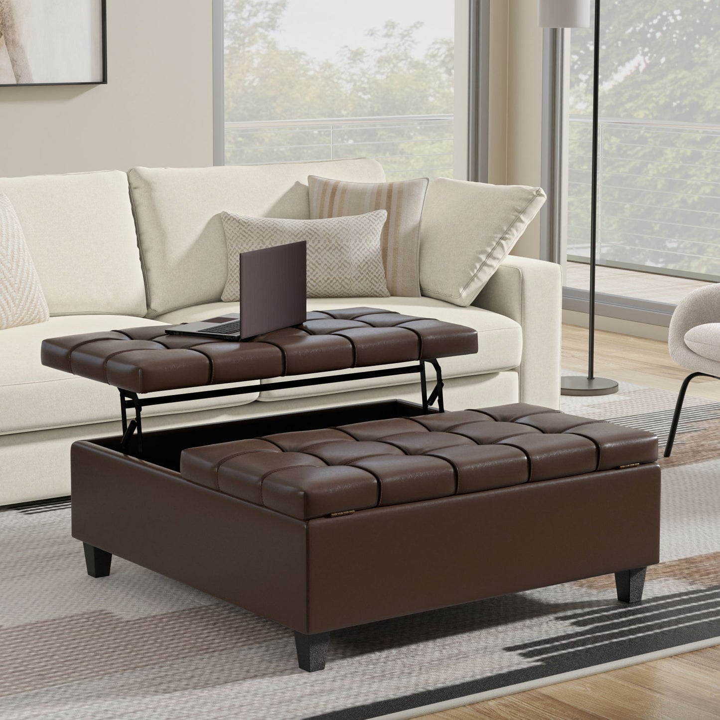 A modern living room showcases a beige sofa and the Harrison - Upholstered Coffee Table Storage Ottoman with a lift-top tray for hidden storage, complemented by large windows and neutral decor.