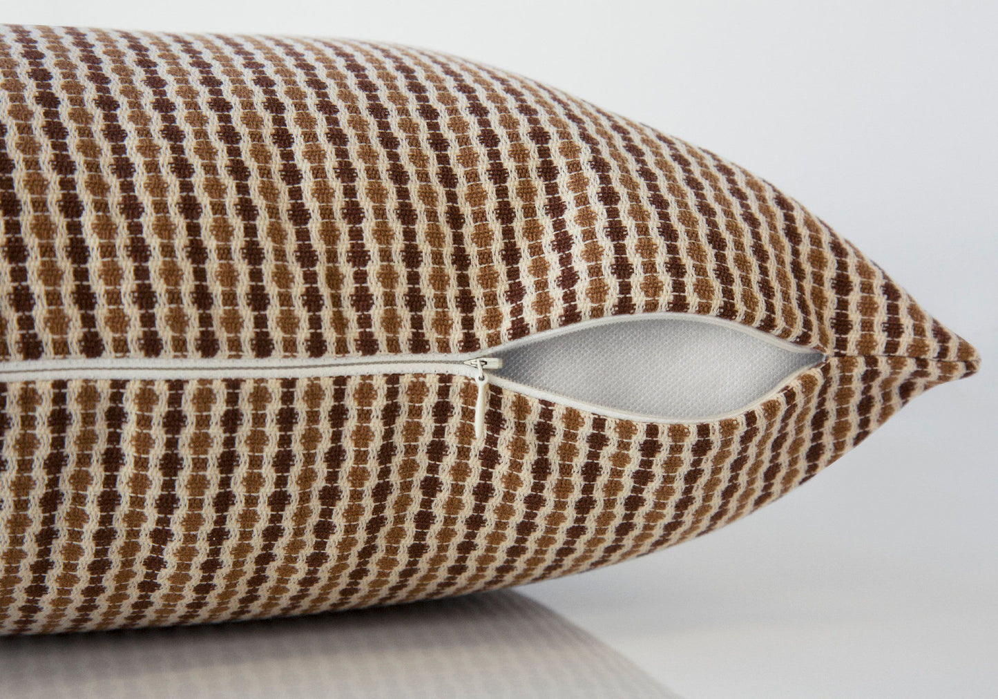 A close-up of the Decorative Throw Pillow, Square with a brown and white checkered pattern and a partially open white zipper on one side. Insert included. Hypoallergenic. Shown against a plain white background.