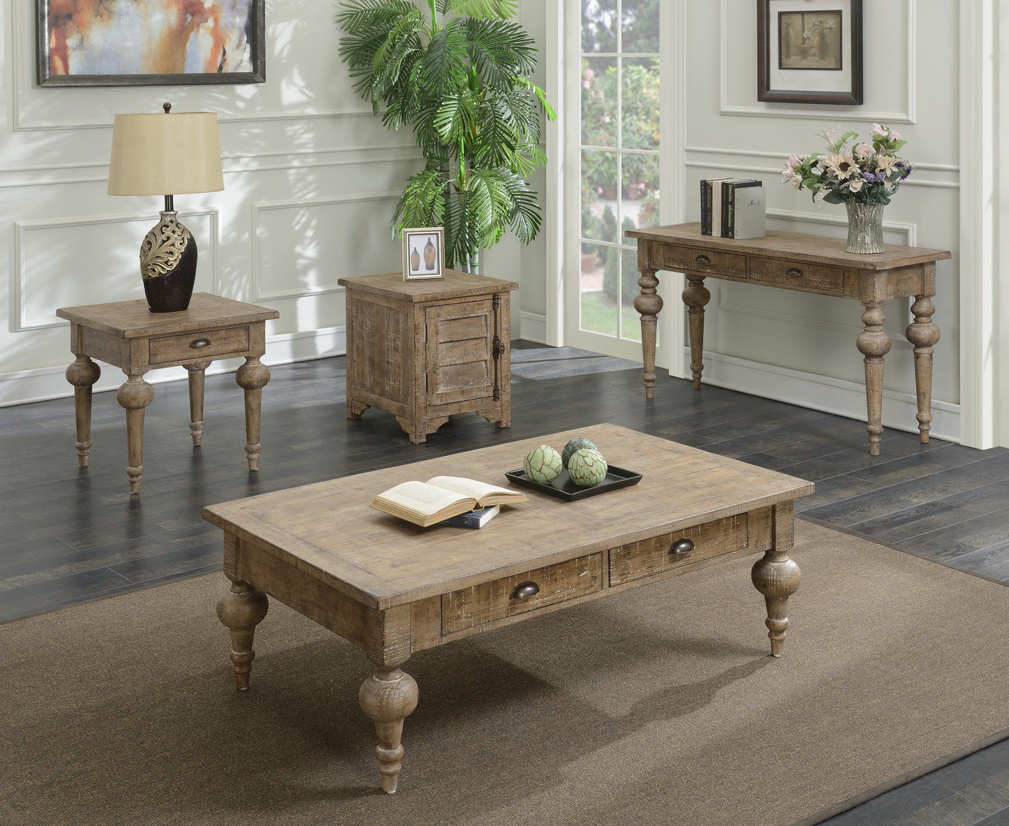 A living room featuring the Ludin - Table with rustic wood design, accompanied by a side table with lamp, a small chest, console table with vase, framed photos, a plant, and large windows brightening the space.