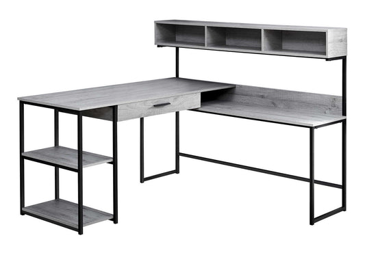The Computer Desk is an L-shaped, modern home office desk with a grey wood finish, black metal frame, left-side shelves, single drawer, and an upper shelf featuring four open compartments for organized storage.