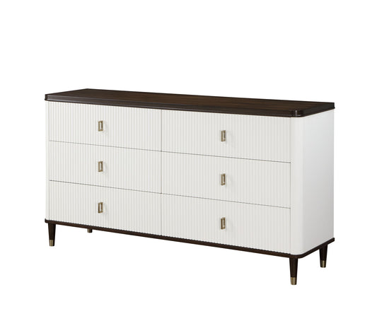 The Carena Dresser With Jewelry Tray in White/Walnut features six drawers with ribbed white fronts, a dark walnut top and base, metallic rectangular handles, and tapered legs accented with brass.