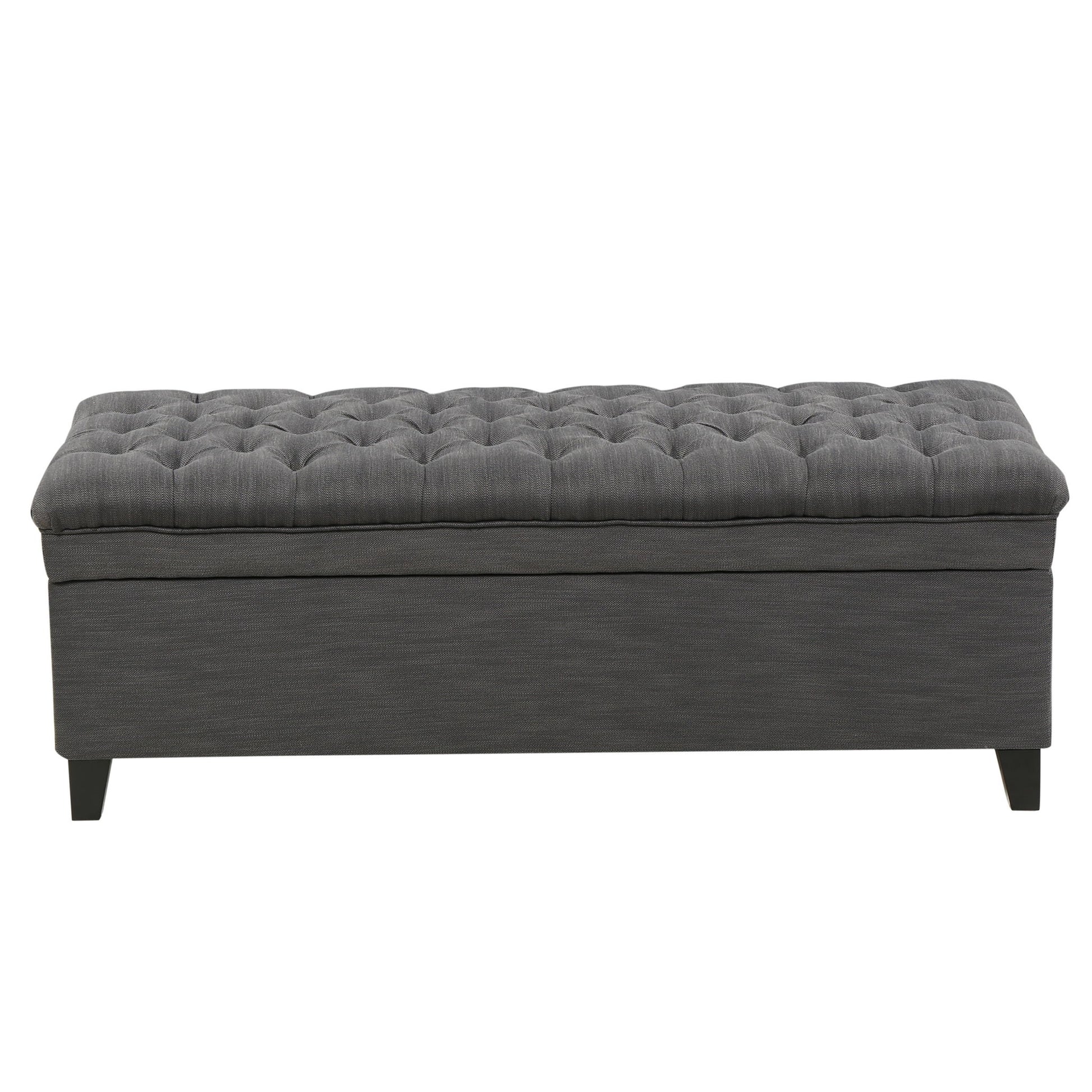 The Juliana Storage Ottoman features a rectangular shape, dark gray upholstery, tufted cushion top, and short birch legs, shown from the front.