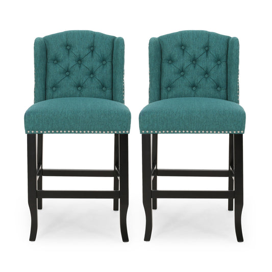 The Vienna Fabric Tufted Counter Stool With Nailhead Accents (Set of 2) features teal upholstery, tufted backs, silver nailhead trim, and dark wooden legs, shown side by side against a white background.