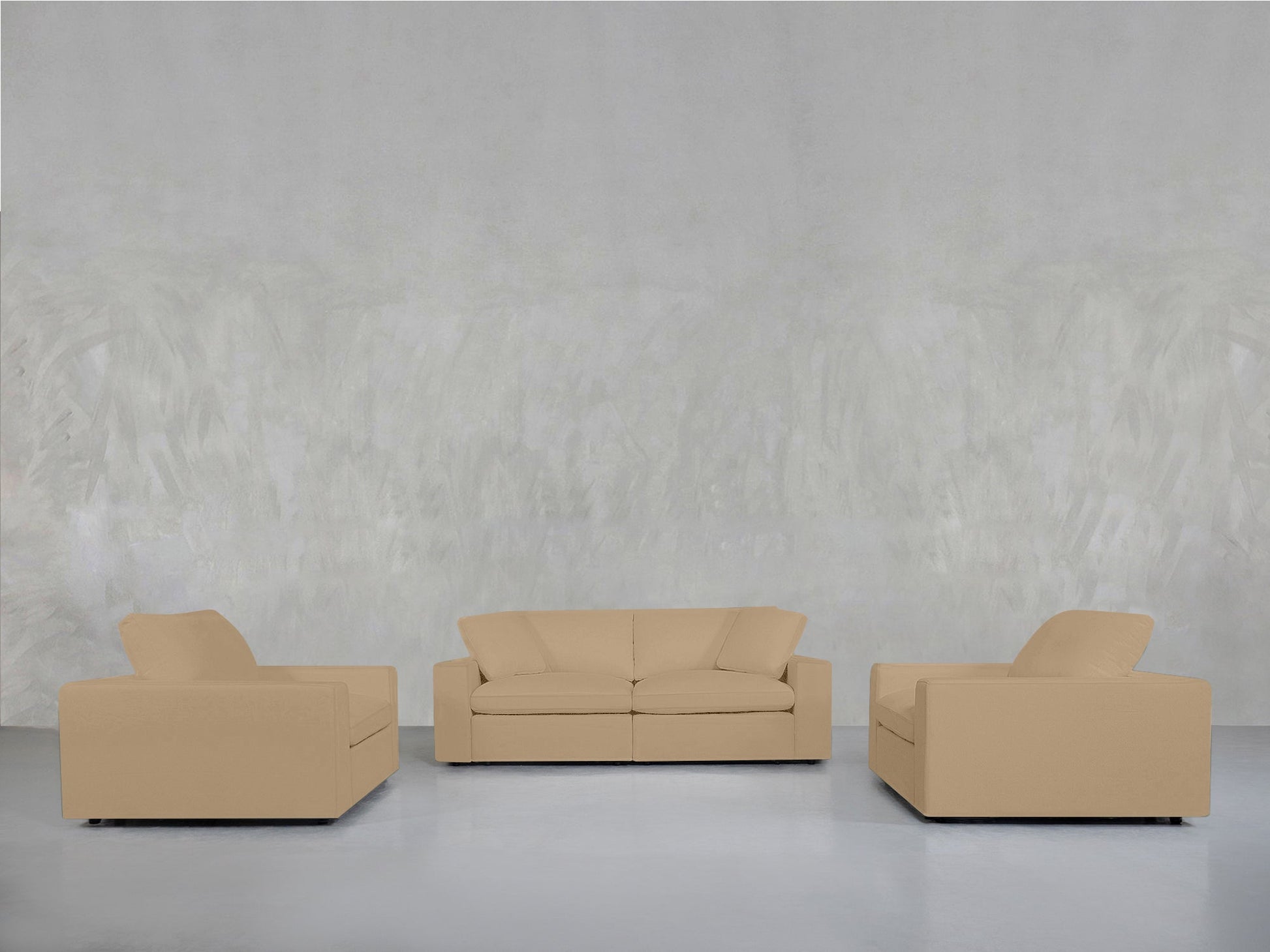 The 2-1-1 Sofa & Armchair Set, featuring a beige upholstered two-seater and two matching armchairs, is arranged in a minimalist layout against a light gray textured wall.