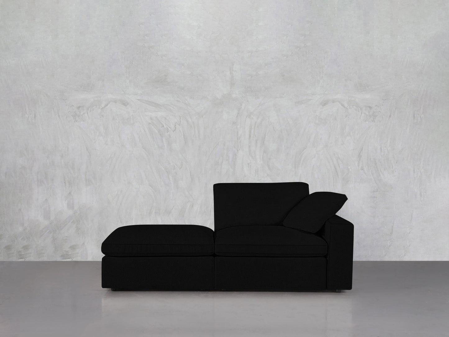 A 2-Seat Modular Lounger Loveseat is placed against a light gray textured wall, resting on a glossy light gray floor.
