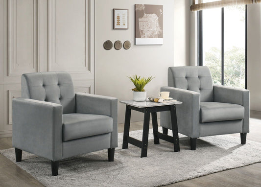 The Hale Velvet Armchairs and End Table Set (3-piece) features two light gray tufted armchairs and a small table, perfect for a bright, modern living room with neutral decor and large windows.