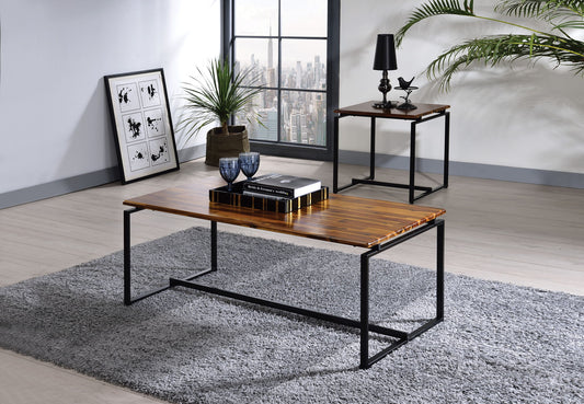 Modern living room featuring the Jurgen - 3 Pieces Pack Coffee & End Set in oak/black on a gray rug, with a plant, decor accents, framed art against the wall, and a city view window in the background.