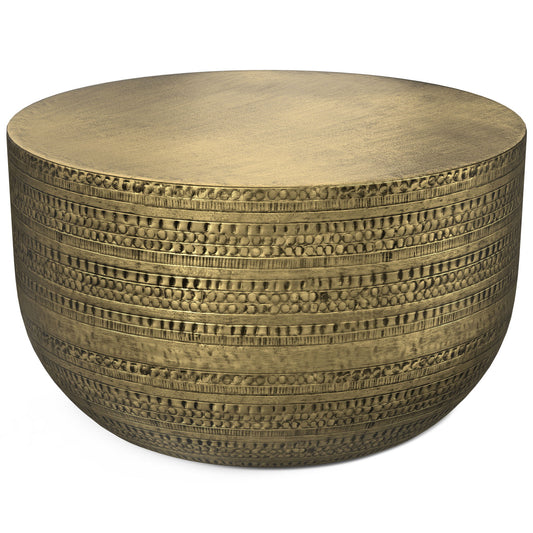 The Johnsen Handcrafted Metal Coffee Table features a round brass design with a textured, patterned surface of horizontal etched lines and dots, offering an ornate, artisanal look.