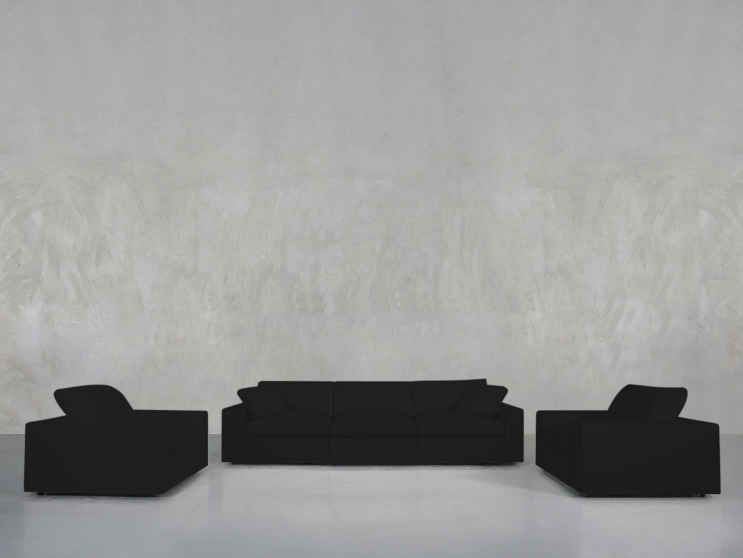 A minimalist living room features the 3-1-1 Sofa & Armchair Set in black, arranged against a plain light gray textured wall and a glossy light gray floor.