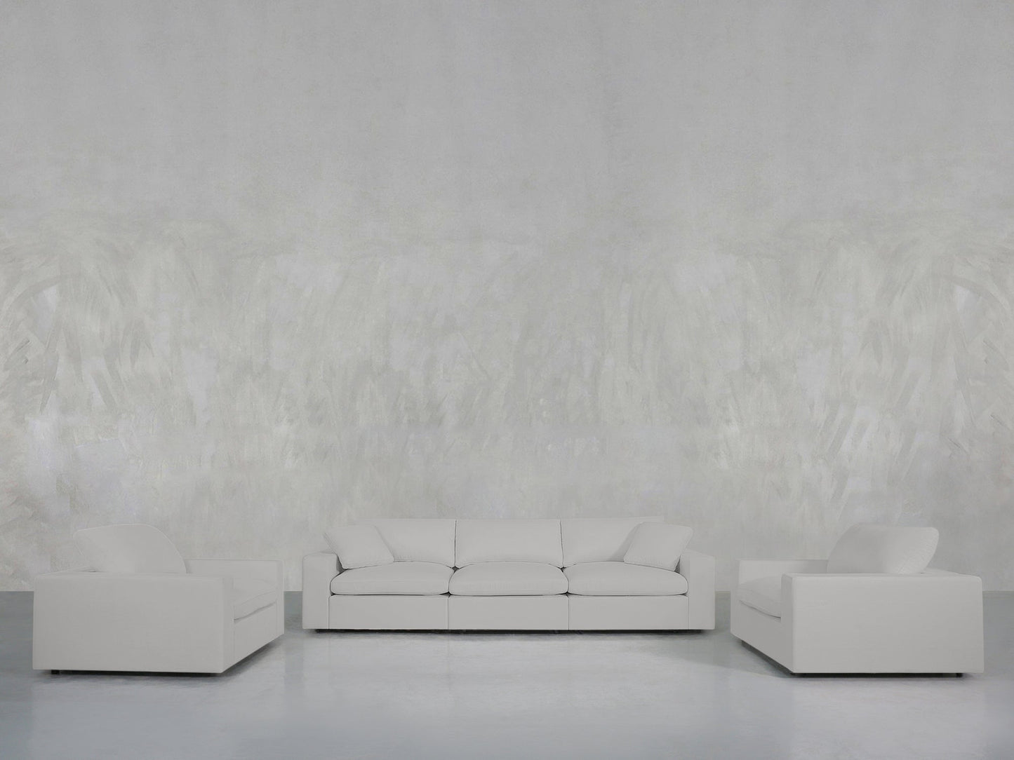 A minimalist living room showcases the 3-1-1 Sofa & Armchair Set with clean lines in white, arranged against a light gray textured wall and a smooth gray floor.