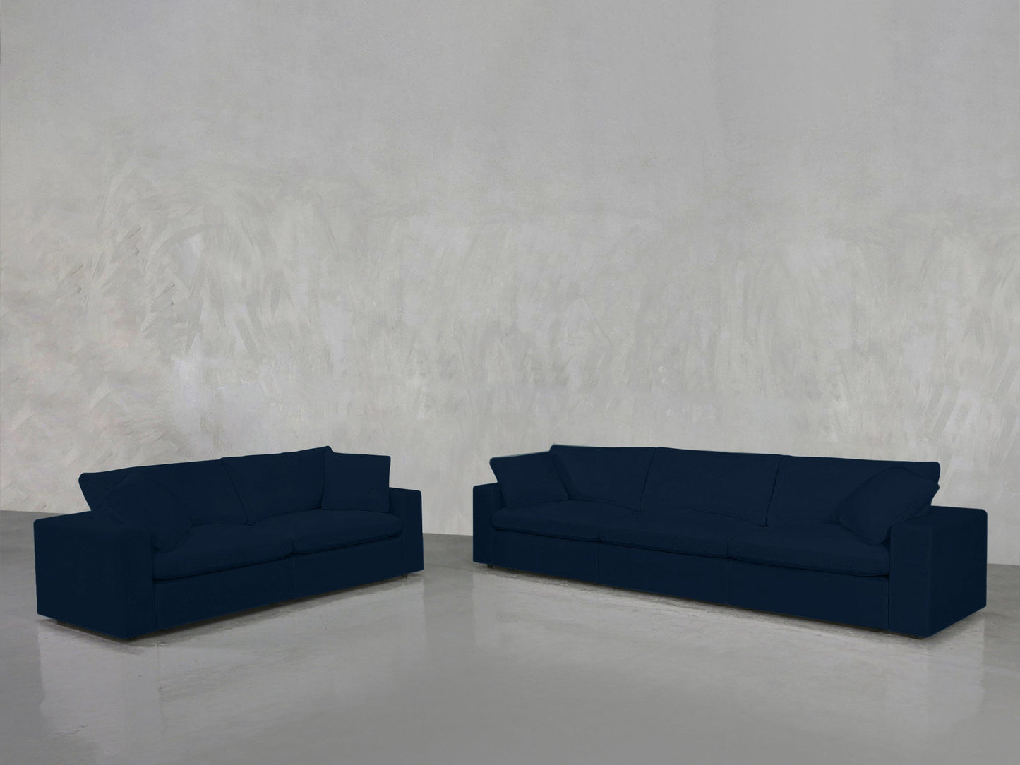 A 3-2 Sofa Set in dark blue is arranged in an empty room with a light gray textured wall and a glossy floor.
