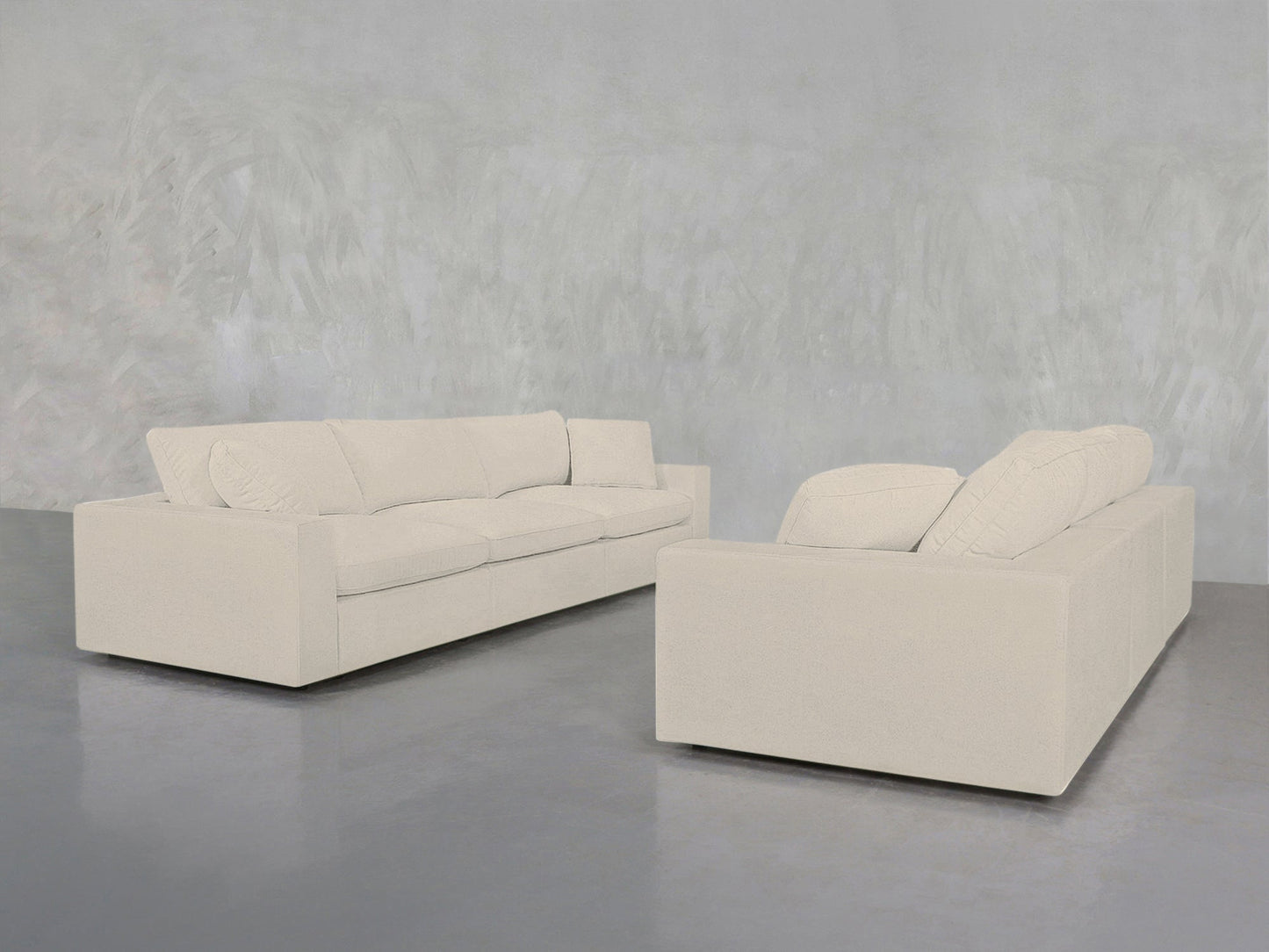 Two modern 3-3 Sofa Set pieces in light beige with clean lines and matching cushions face each other in a minimalist room featuring a smooth gray floor and a textured light gray wall.