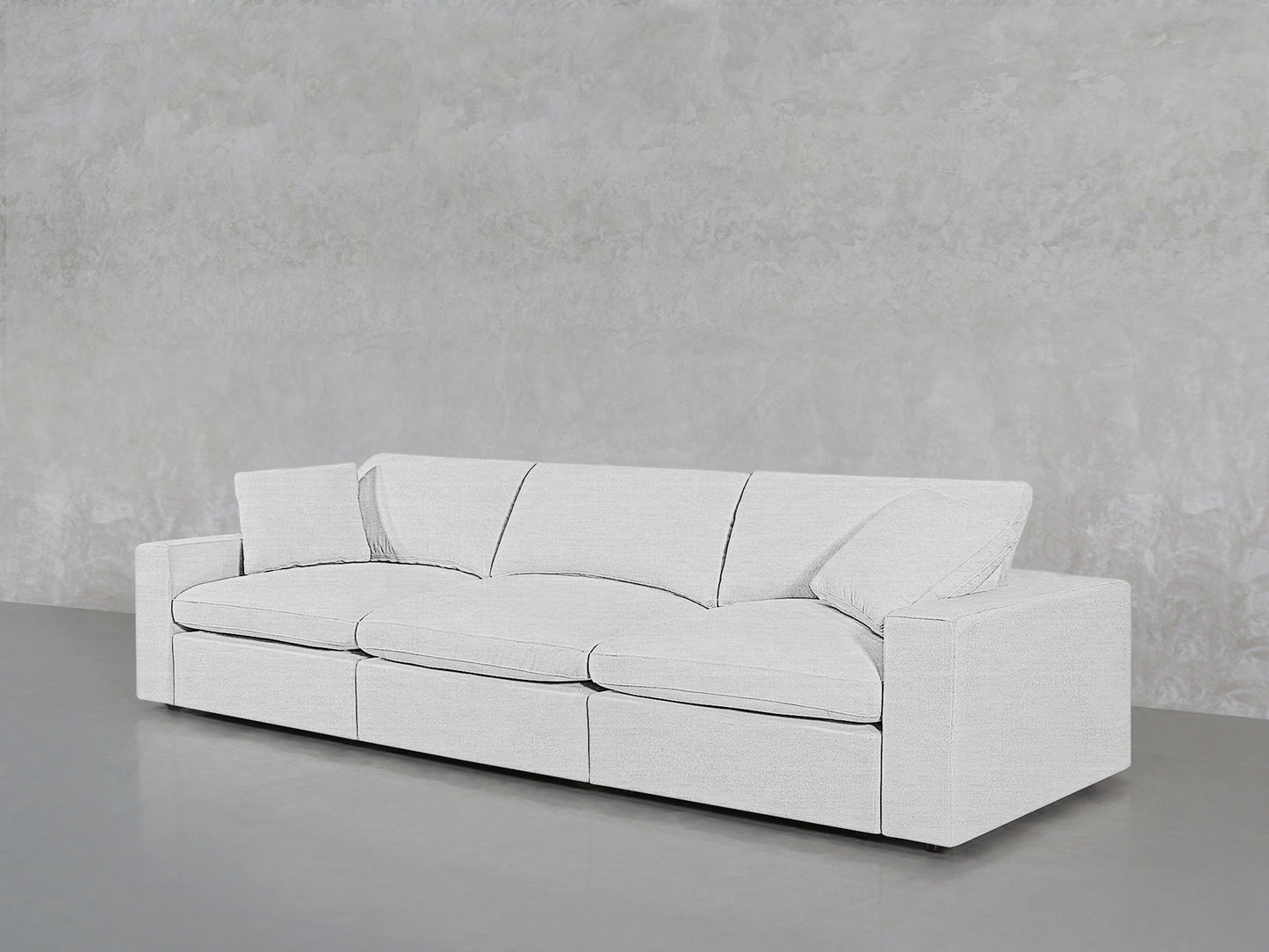 The 3-Seat Modular Sofa, featuring a minimalist white design with three seat cushions and square armrests, is set against a light gray textured wall on a smooth gray floor.