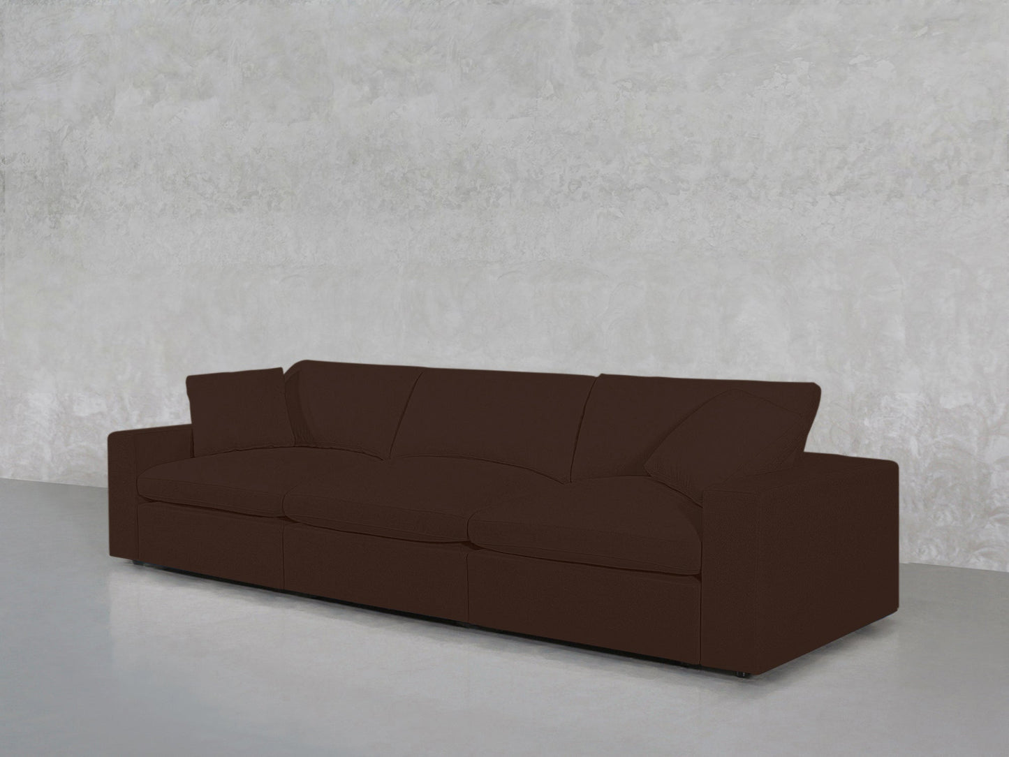 The 3-Seat Modular Sofa features a modern design with dark brown upholstery and square arms, shown against a light gray textured wall and polished concrete floor.