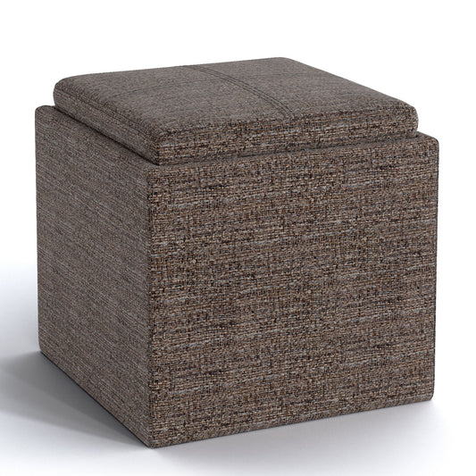 The Rockwood Upholstered Cube Storage Ottoman With Tray is a square, brown, fabric ottoman featuring a cushioned lid and modern design, shown on a white background.