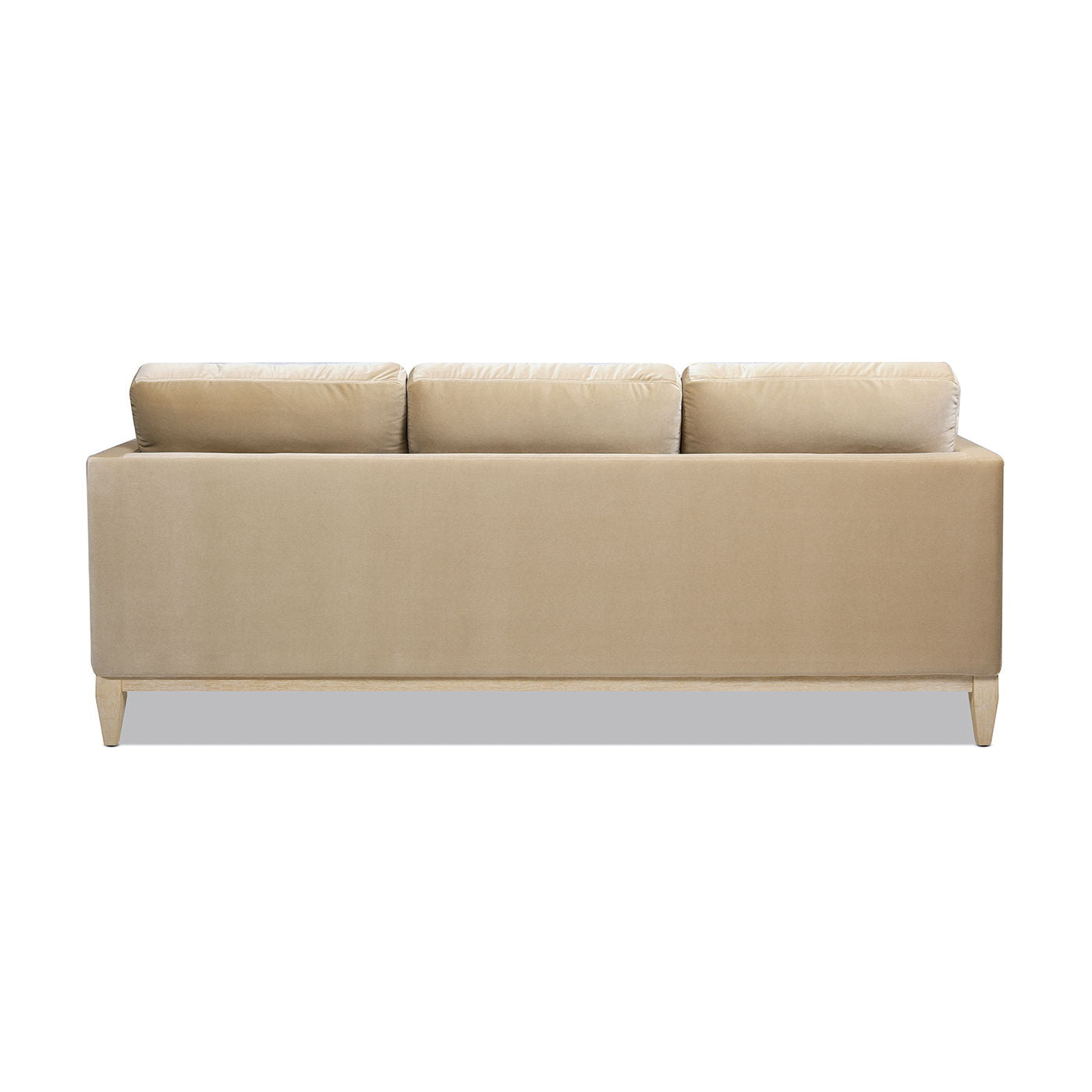 The Knox - Modern Farmhouse Sofa is a beige, three-seater with a simple modern design and low wooden legs, shown from the back against a white background.