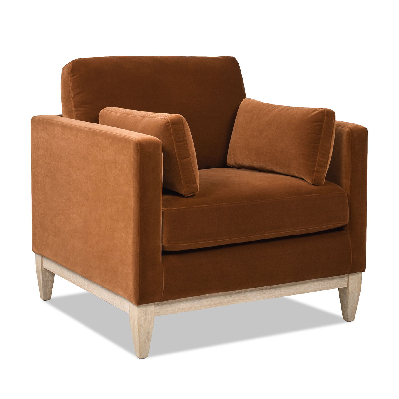 The Knox - Modern Farmhouse Arm Chair features plush burnt orange velvet upholstery, two matching rectangular cushions, and light wooden legs, displayed against a white background.