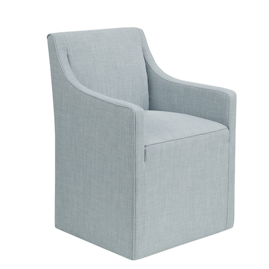 The Traditional Skirted Dining Arm Chair is upholstered in light blue fabric, featuring a boxy, straight-edged design and a skirted base, shown against a white background.