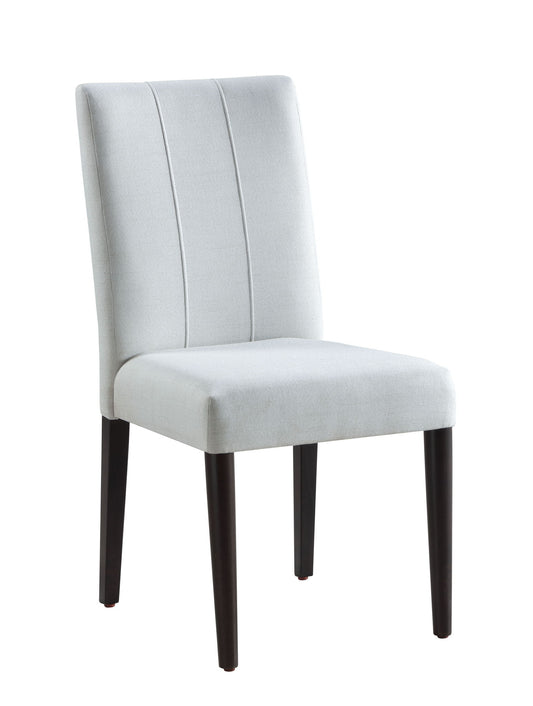 The Carena Side Chair (Set of 2) in white features a modern armless design with a white upholstered seat and backrest, subtle vertical stitching, and four dark wooden legs.