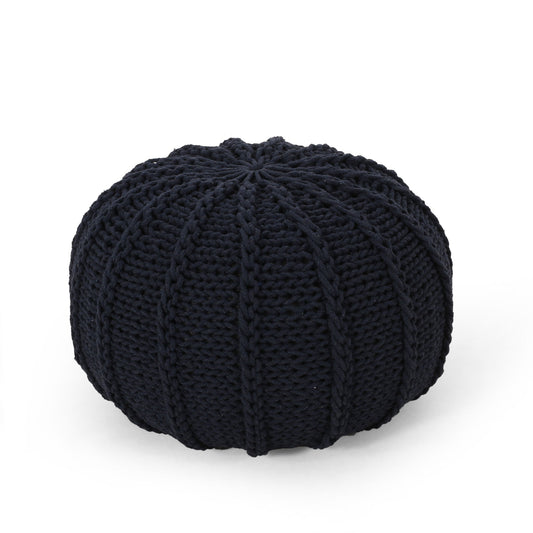 The Bordeaux Knitted Cotton Round Pouf Ottoman and Floor Cushion features a black, ribbed design with thick visible yarn, showcased on a plain white background.