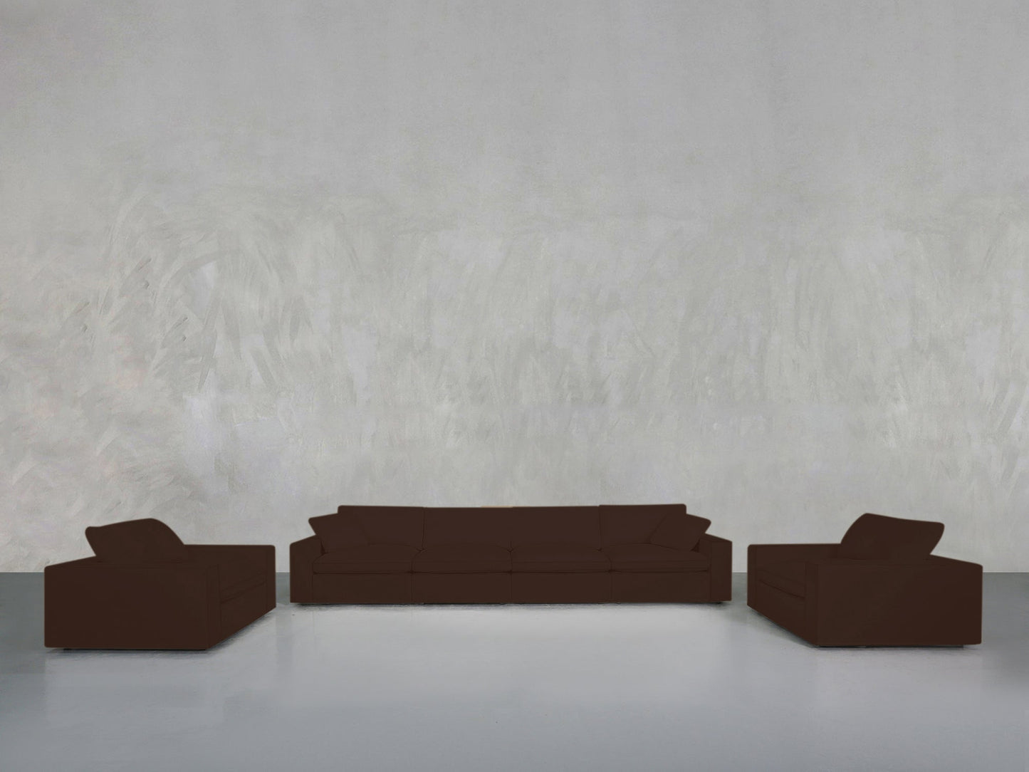 The 4-1-1 Sofa & Armchair Set, in dark brown, is arranged in a minimalist room with a light gray textured wall and smooth white floor—two armchairs face each other, while the larger sofa sits between them against the wall.