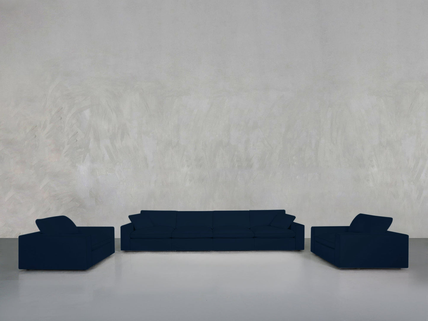 Minimalist living room featuring the 4-1-1 Sofa & Armchair Set in dark blue, arranged on a glossy light gray floor with a textured pale gray wall backdrop.