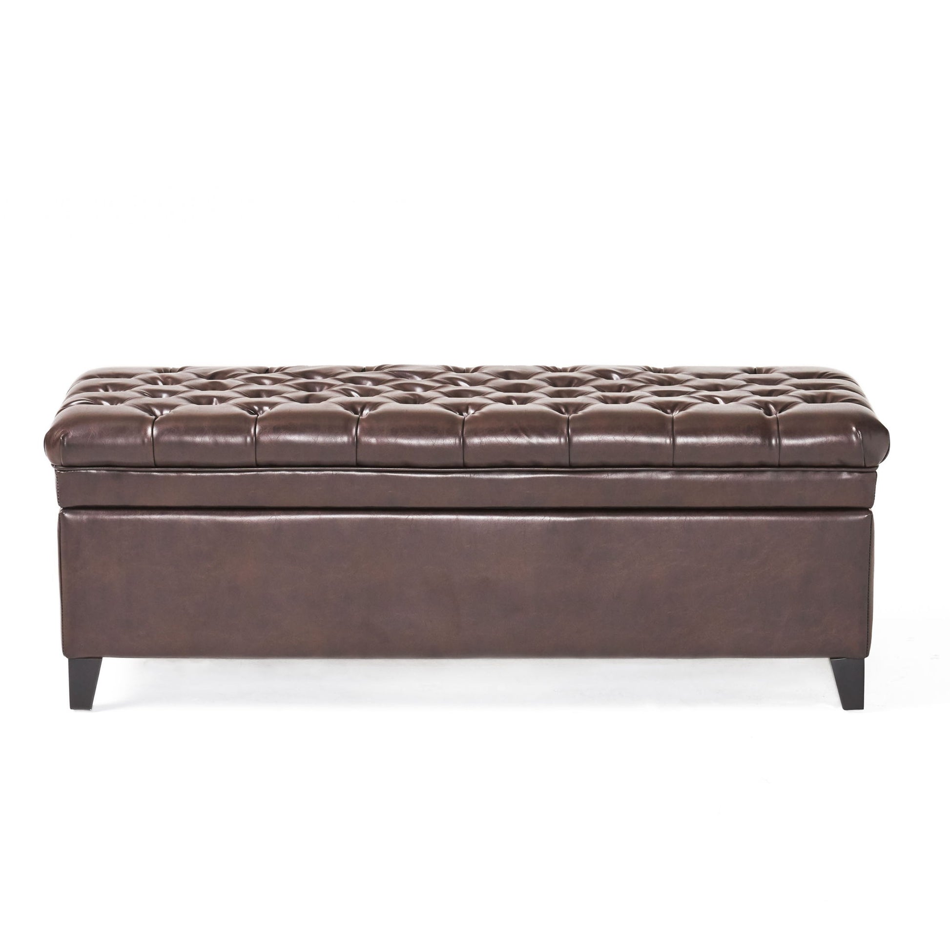 The Juliana Storage Ottoman features dark brown tufted leather with button detailing on the lid, smooth base, and short birch legs. Shown from the front against a white background.