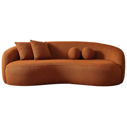 The Drake - Japandi Style Curvy Boucle Sofa features a modern curved design in burnt orange, textured boucle fabric, and comes with two matching square pillows and two round accent cushions. Shown isolated on a white background.