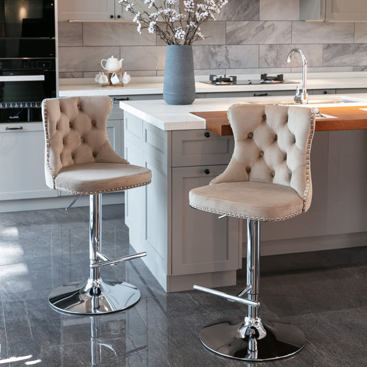Two Swivel Velvet Barstools with adjustable seat height (25-33"), tufted backs, and chrome bases sit at a modern kitchen island with gray cabinets, built-in stove, a floral vase, and matching gray tile floor and backsplash.