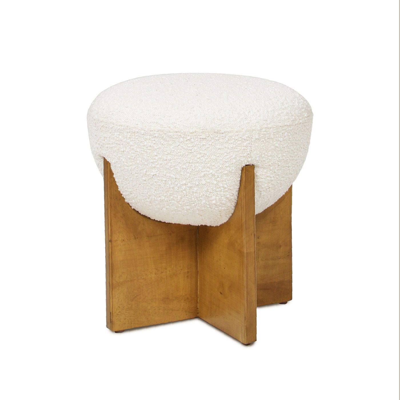 The Bali - Round Upholstered Ottoman features a modern design with a textured white cushion and a wooden base composed of four intersecting panels forming an X shape.