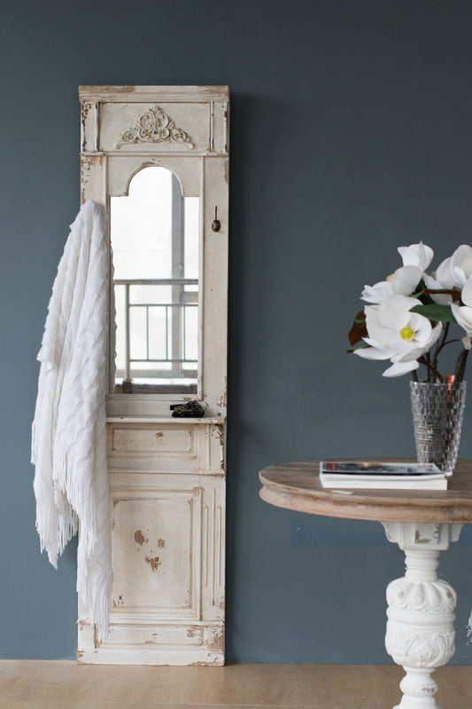 A vase with a white flower sits on a table beside the Classic Vintage Antique Wall Mirror, French Country Wall Decor - White.