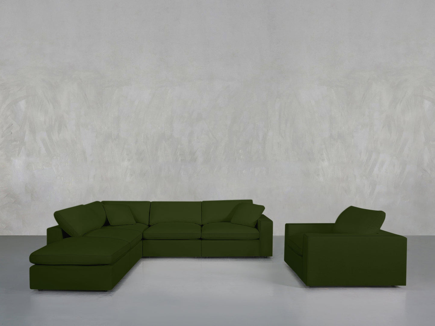 The 5-1 Sectional & Armchair Set in olive green, featuring an attached chaise, rests on a light gray floor beside its matching armchair, all set against a plain textured light gray wall.