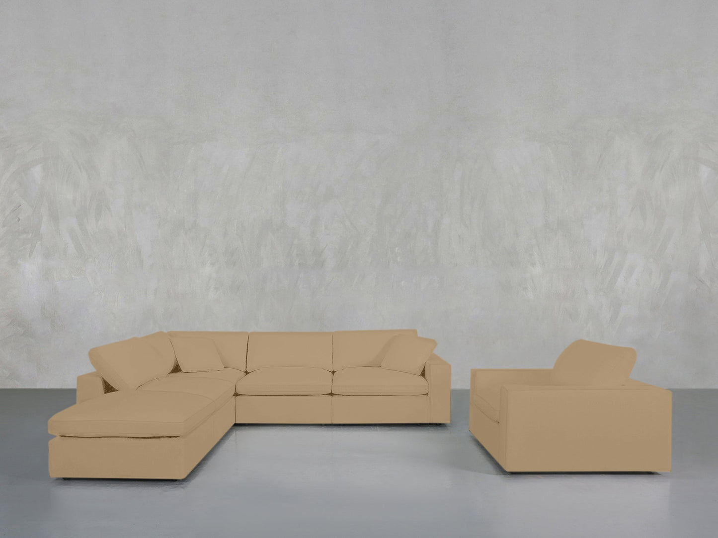 The 5-1 Sectional & Armchair Set, featuring a beige L-shaped sofa and matching armchair, is arranged in a minimalist room with a light grey textured wall and smooth grey flooring.