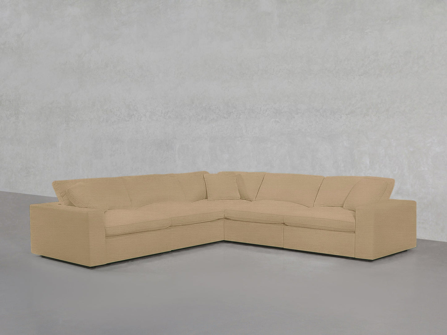 5-Seat Modular Corner Sectional with plush beige cushions, arranged in an L-shape against a plain light gray textured wall and floor.