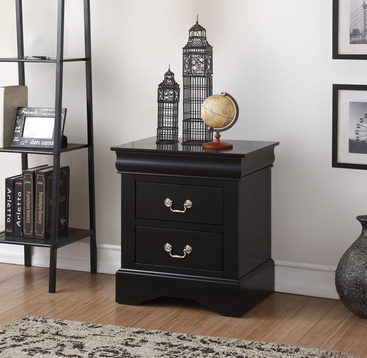 The Louis Philippe III nightstand, featuring two drawers with silver handles, sits on a wooden floor. Decor includes a globe, metal Big Ben models, books on a black shelf, a patterned rug, and black-and-white framed photos.