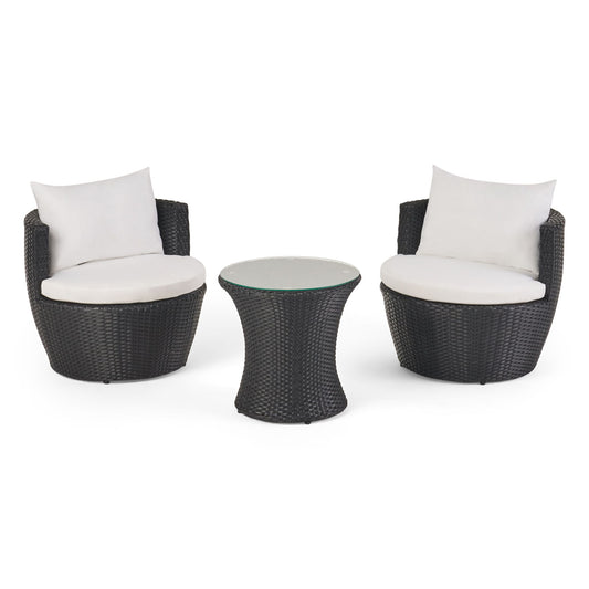 The Kono - Chat Set Outdoor Furniture features two round black wicker chairs with white cushions placed on either side of a matching small round wicker table with a glass top.