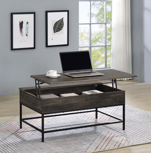 The Cliff - Modern Design Table with a lift-top surface holds a laptop and cup, while books are stored in the open compartment. Set on a rug, it complements a modern living room with framed art and large windows.