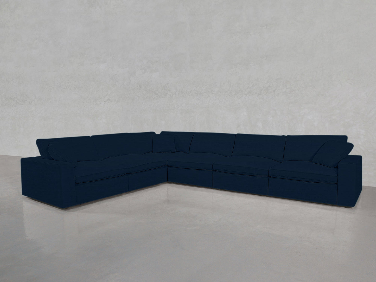 A 6-Seat Modular Corner Sectional in dark blue sits on a shiny light gray floor against a plain light-colored wall.