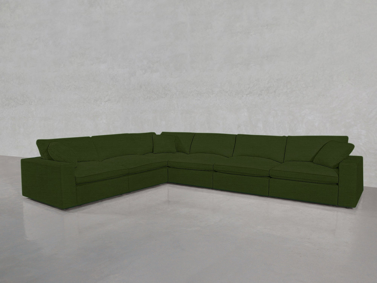 A 6-Seat Modular Corner Sectional in dark green is set in an empty room with light gray walls and a glossy, light-colored floor.