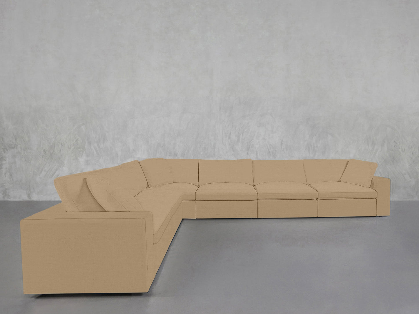 A 6-Seat Modular Corner Sectional in beige is arranged against a light gray textured wall on a smooth gray floor.