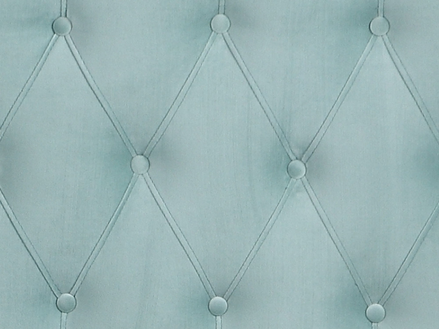 Close-up of the Luma Upholstered Bed's light blue tufted fabric, featuring diamond-shaped stitching and buttons at each intersection for a quilted, padded texture.