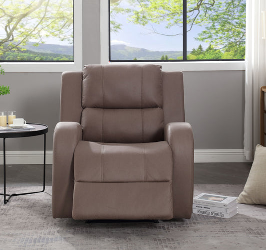The Modern Soft Manual Recliner Chair, in plush brown, sits in a modern living room beside a round side table with drinks, books on the floor, a pillow, and large windows showcasing green trees and a bright sky outside.