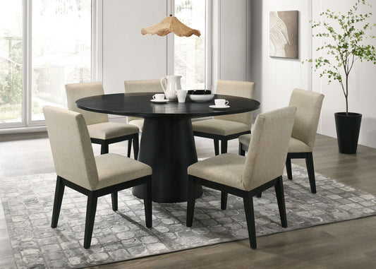 A modern dining room features the Jasper Round Dining Table Set with a black table and six beige chairs, a pendant lamp overhead, a potted tree by the window, and tableware on a gray patterned rug.
