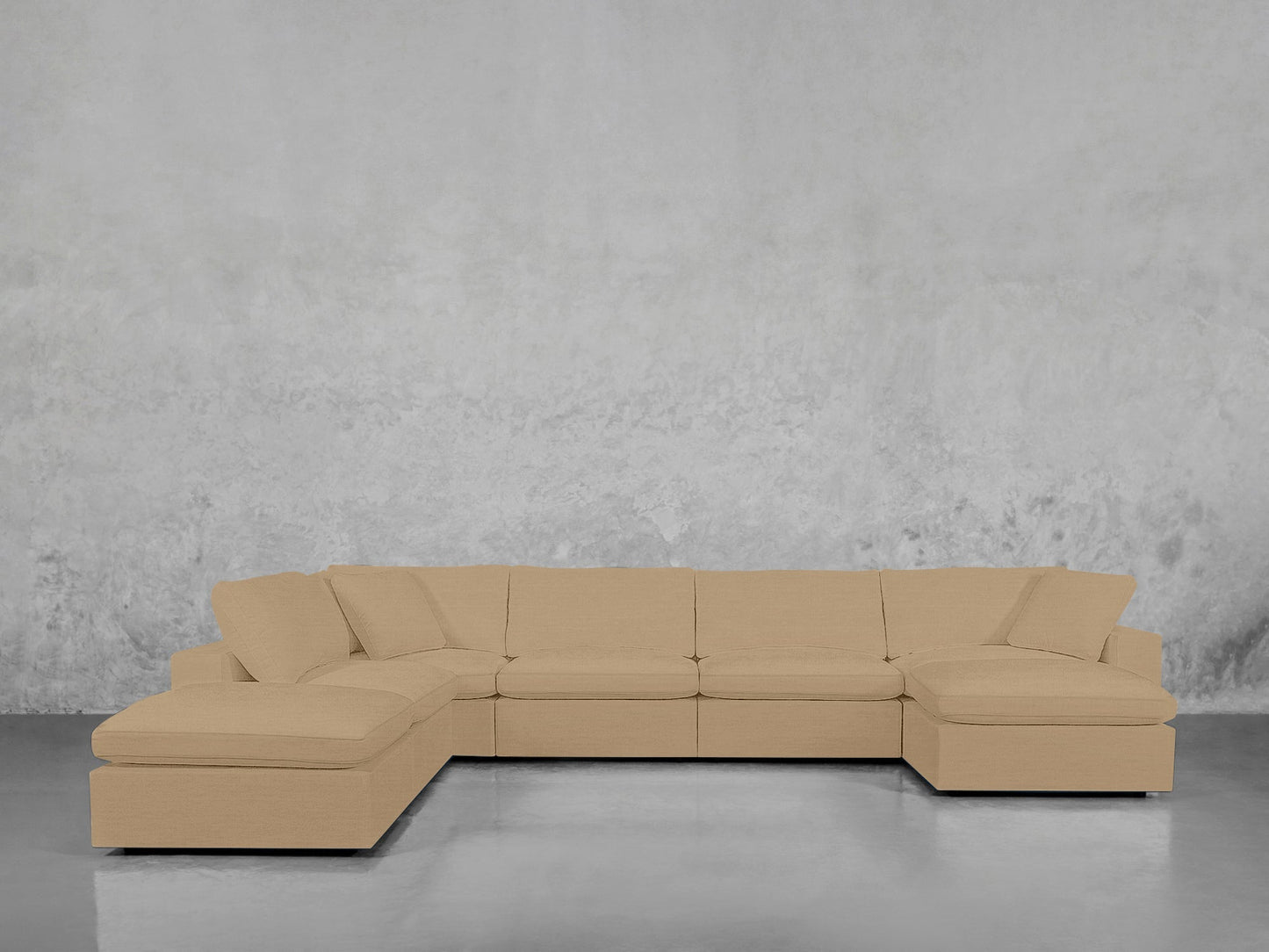 A 7-Seat Modular Chaise Corner Lounger Sectional in beige with plush cushions is placed against a light gray textured wall on a shiny, reflective floor.