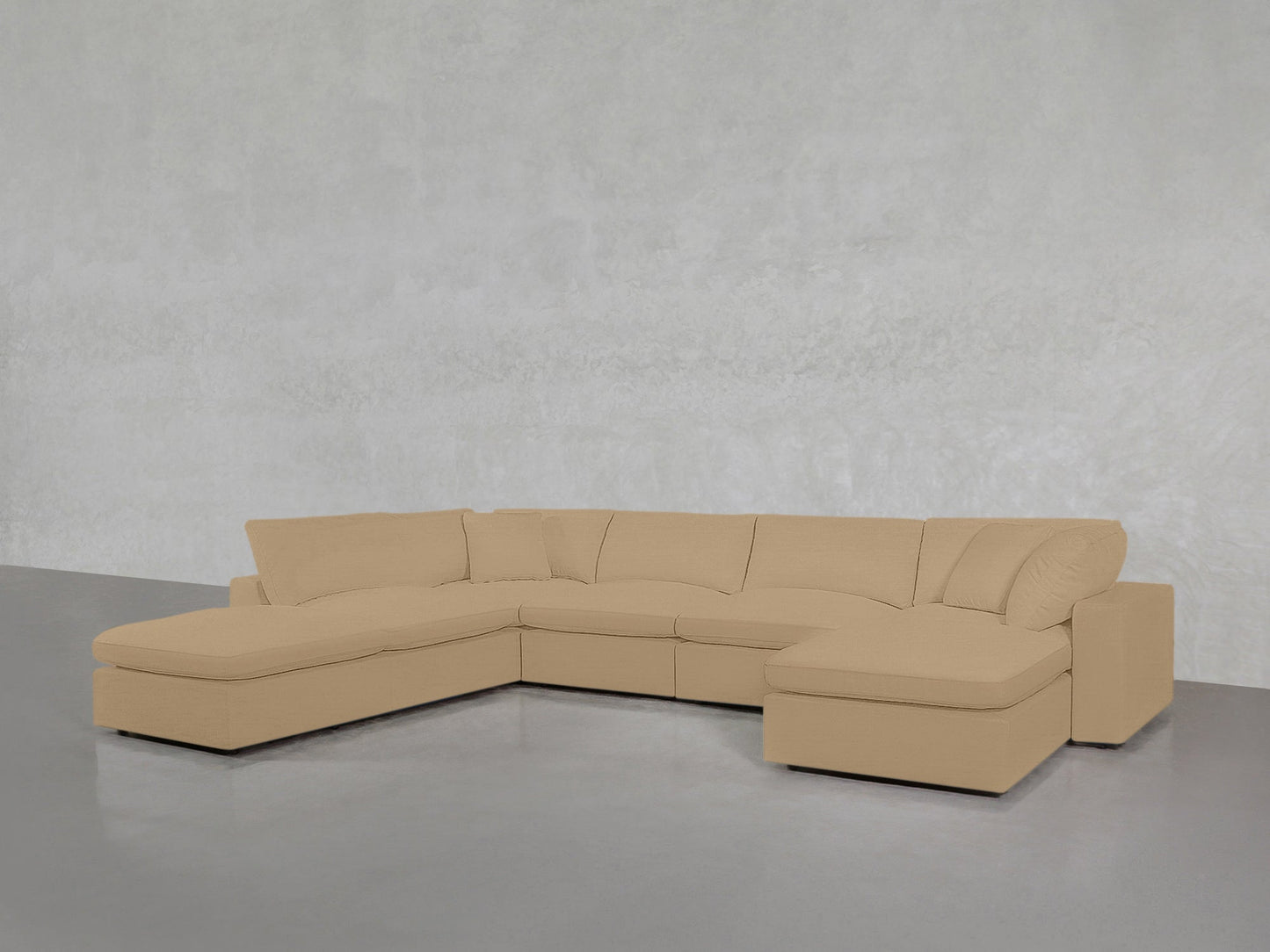 The 7-Seat Modular Chaise Corner Lounger Sectional, in beige with plush cushions and chaise lounges at both ends, is set against a light gray wall and smooth gray floor.